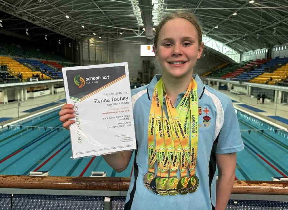 Sienna Toohey with her medals and certificate after being named female swimmer of the meet at the School Sport Australia Swimming Championships.