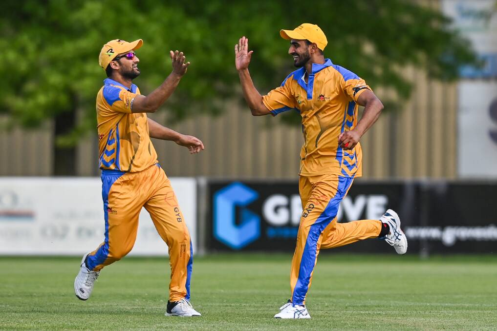 New City's Manjit S Kalsi and Gurmeet Singh celebrate the fall of a Tallangatta wicket. Picture: MARK JESSER