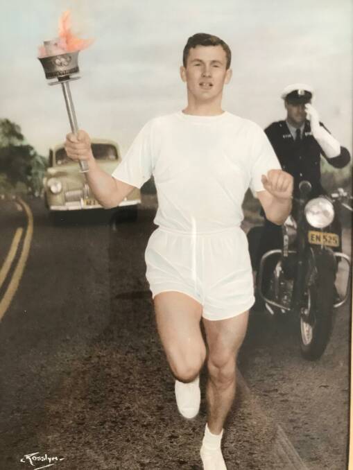 John Reid carrying the Olympic torch in 1956.