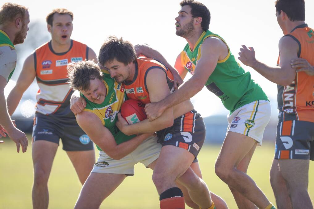 Brian Lieschke finds himself under pressure from two Holbrook players. Picture: JAMES WILTSHIRE