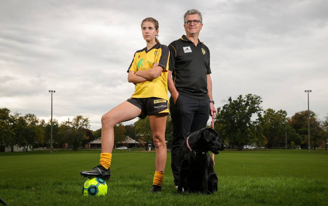 FAMILY CONNECTION: Albury Hotspurs forward Elisha Wild with her father and coach Justin Wild and the family dog Luna. Picture: JAMES WILTSHIRE