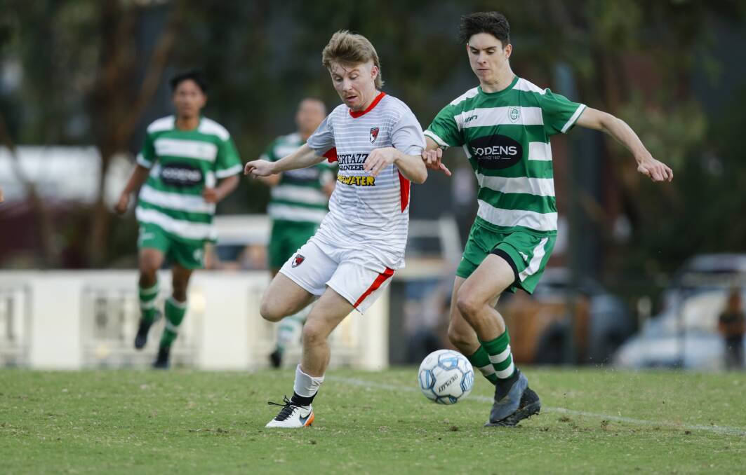 Albury United's Alex Howard battles with Kye Halloway of Boomers. Picture: ASH SMITH