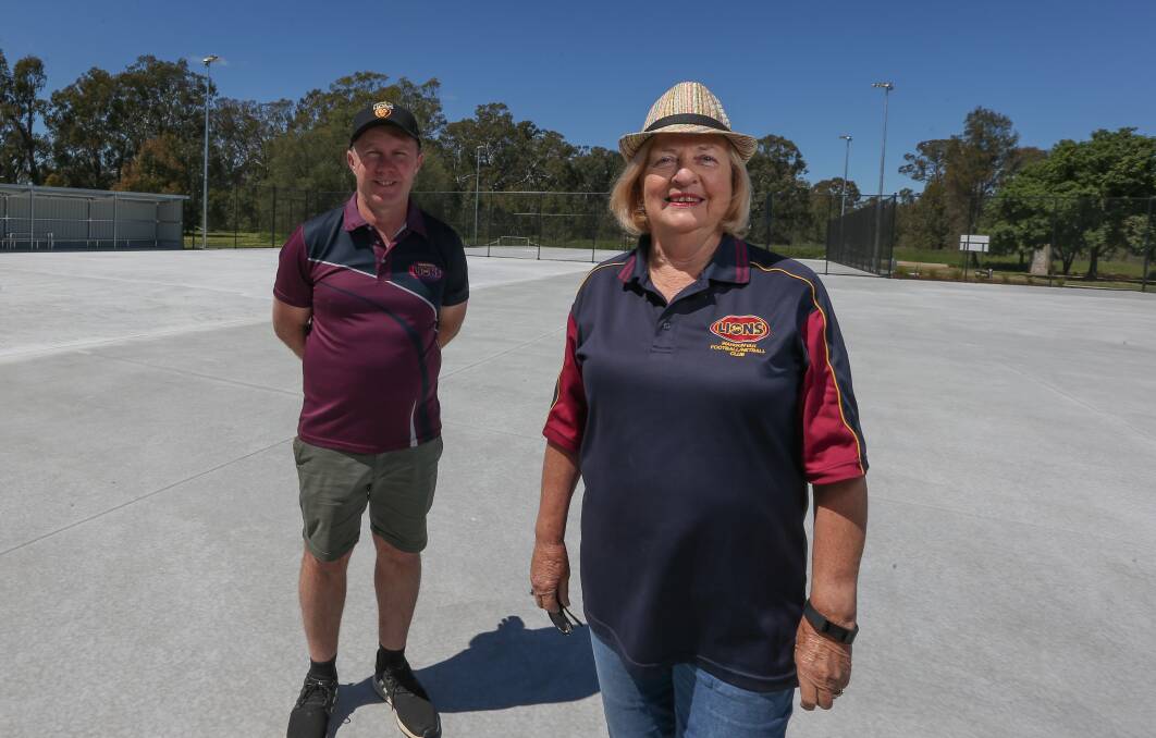 LION HEARTS: Wahgunyah Football Netball Club president Darren Harvey and Wahgunyah Tennis Club president Sandra Johnstone on the newly-laid courts which will be used for netball and tennis. Picture: TARA TREWHELLA