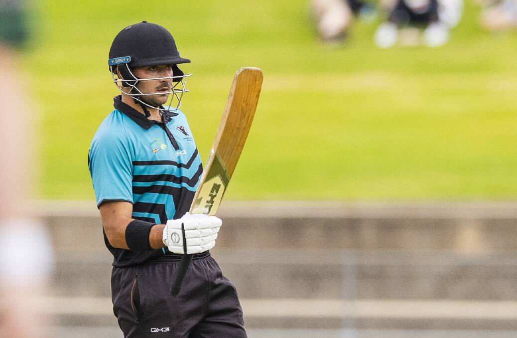 Chris Galvin raises the bat after getting to 50 in the grand final. Picture by Ash Smith