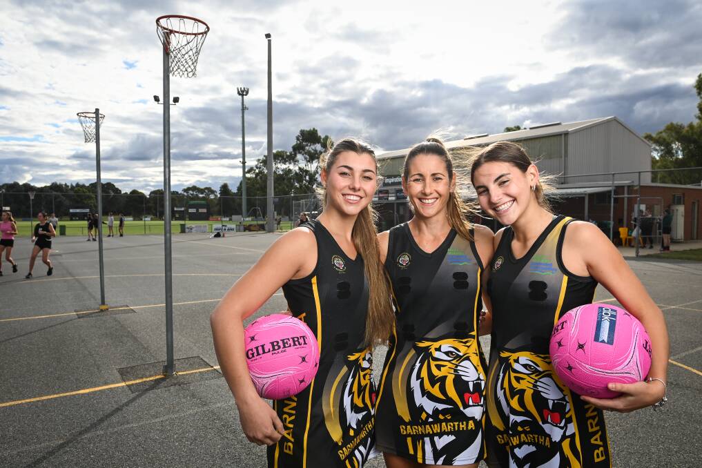 Barnawartha netballer Michelle Anderson (centre) with daughters Imogen, 18, and Brooke, 16. Michelle plays her 350th game for the Tigers on Saturday. Picture by Mark Jesser