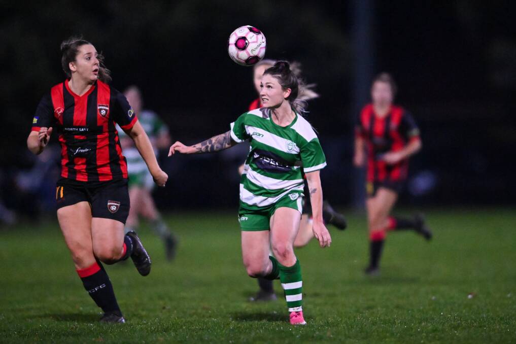 EYES ON THE PRIZE: Paula Mitchell gets Albury United moving against Wangaratta, with Melissa Scott tracking her closely. Picture: MARK JESSER