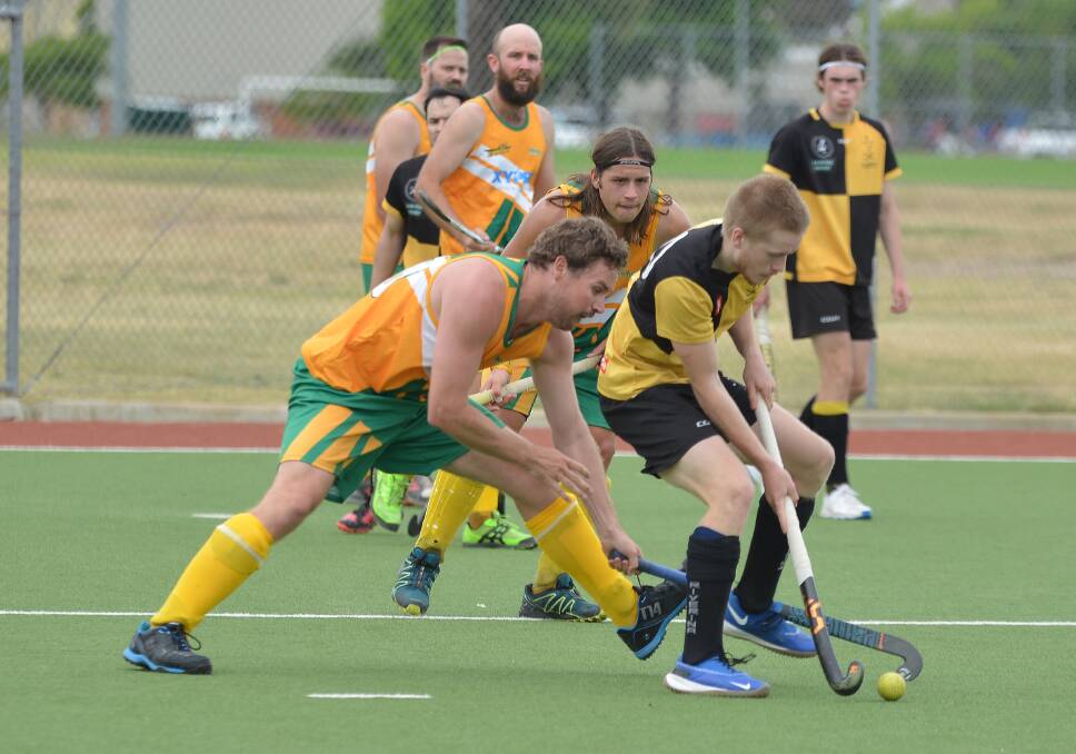 Dave Foster goes in for a tackle as Tim Smith watches on. Picture: NARELLE HAMILTON