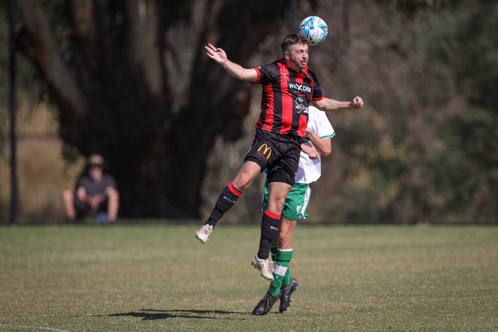 Dan Kelly wins a header during Wangaratta's 2-1 win over Albury United in round one. Picture: JAMES WILTSHIRE
