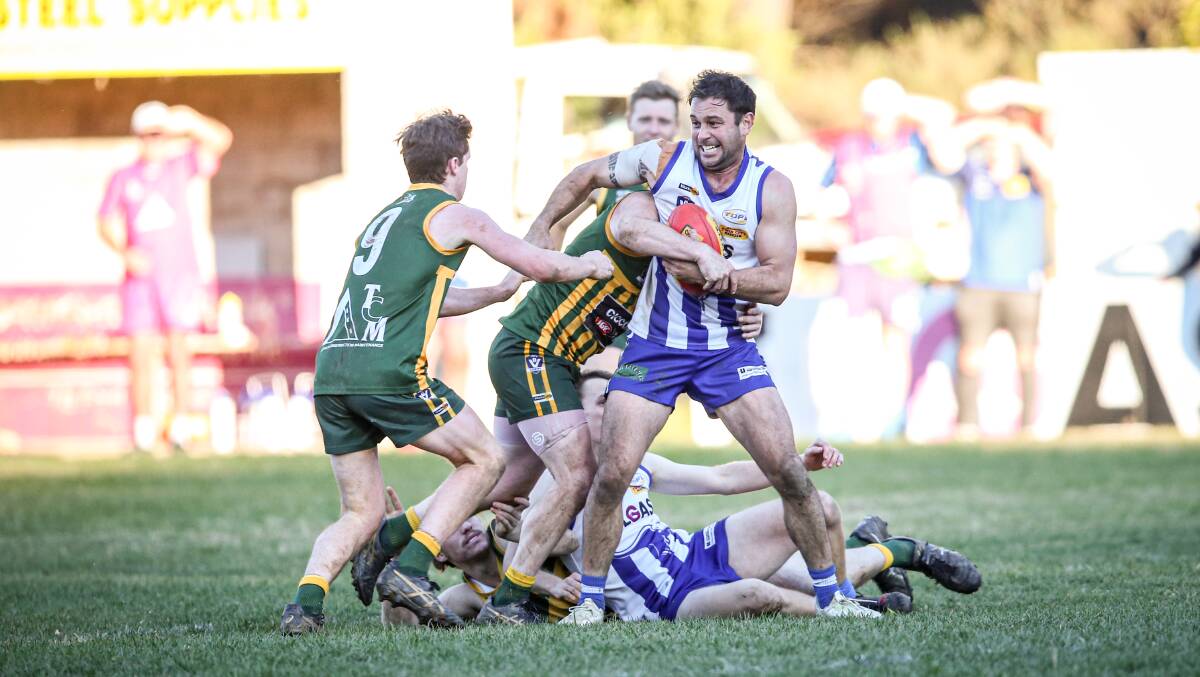 TIGHT TUSSLE: Yackandandah's Josh Garland takes on a tackle as Daniel O'Connell arrives to provide further opposition. Picture: JAMES WILTSHIRE