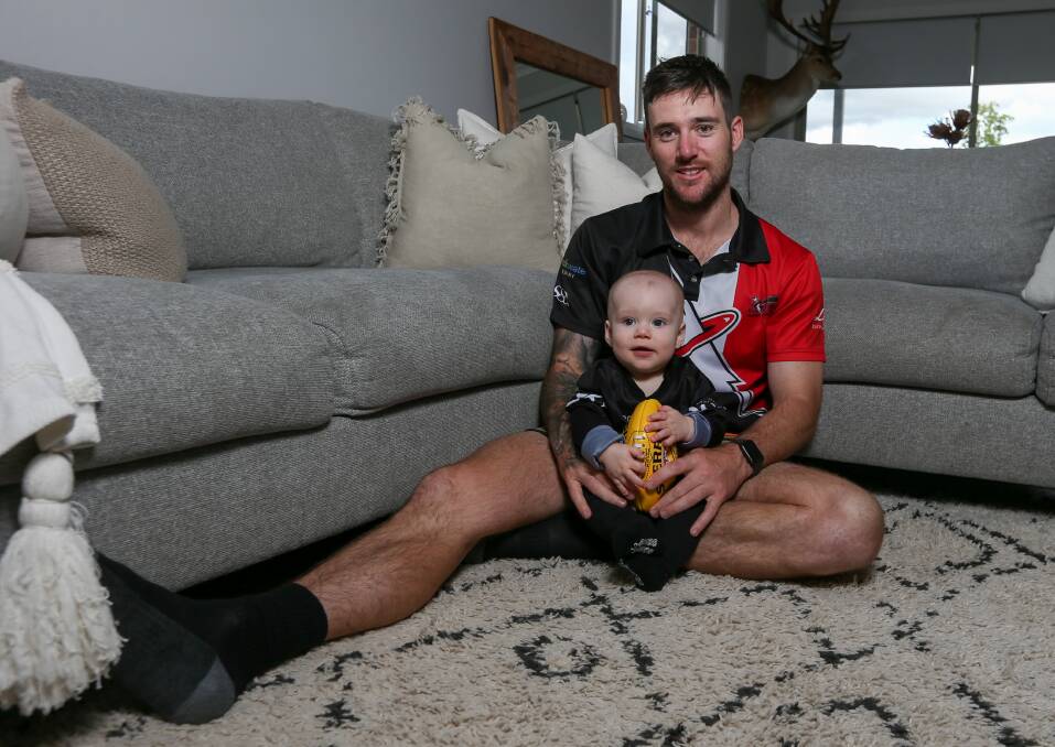 FAMILY MAN: Brock-Burrum midfielder Tyson Neander at home with his eight-month old son Hudson. This season he tied for the club's best-and-fairest with three-time winner and assistant coach Matt Seiter. Picture: TARA TREWHELLA