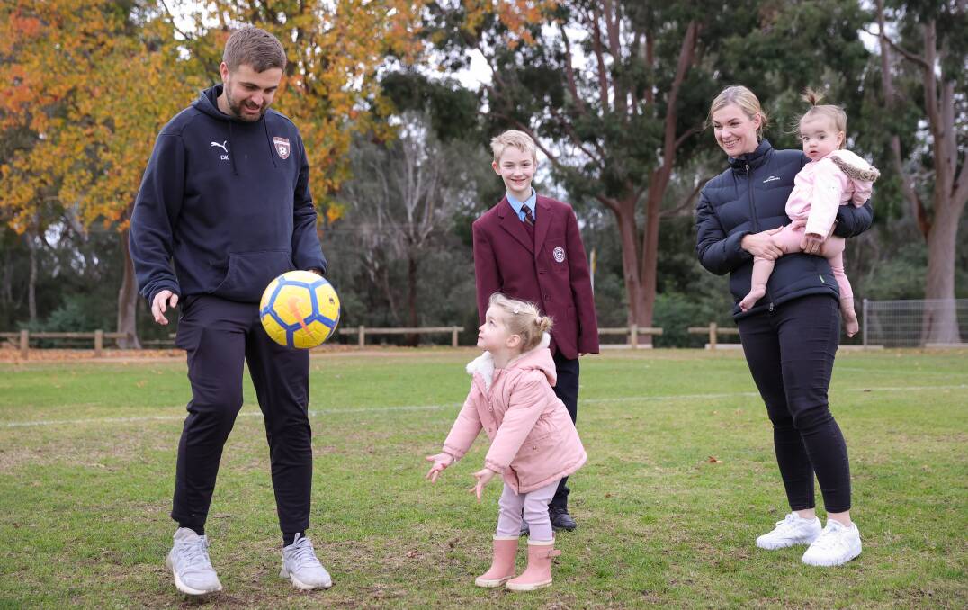 HAVING A BALL: Dan Kelly and Sarah Morris will be cheered on in tonight's FA Cup finals by Mitchell, 12, Penelope, two, and Matilda, one. Wangaratta's women face Hotspurs before the men take on United. Picture: JAMES WILTSHIRE