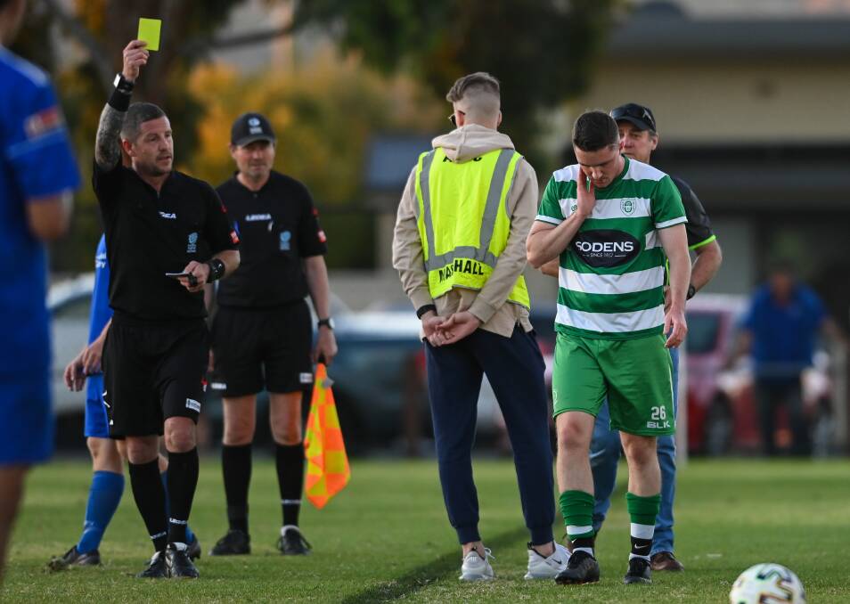 Daniel Moore pulls out his yellow card during the derby clash between Albury United and Albury City. Picture: MARK JESSER