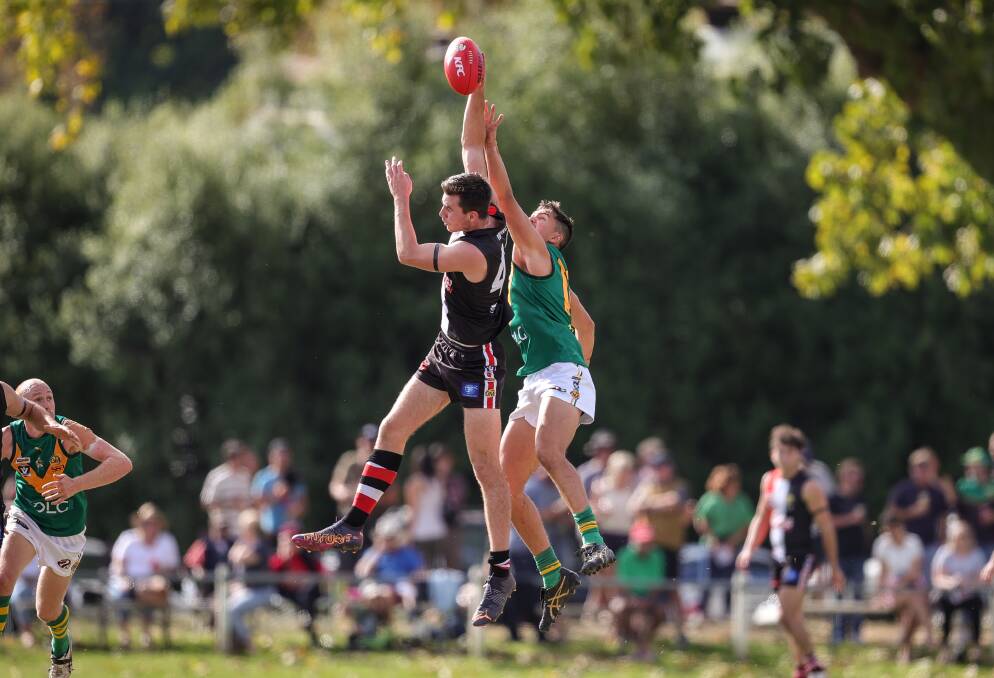 TALL TIMBER: Will McKerral gets the jump on North Albury's Tom Sharp during the Saints' comfortable home win on Easter Sunday. Picture: JAMES WILTSHIRE