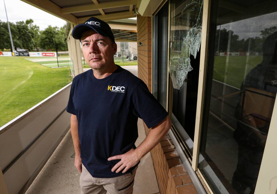 JUST NOT CRICKET: Cameron Walker, president of Albury Cricket, next to the window of the Billson Park club rooms which was smashed by vandals. The break-in will cost the club up to $10,000. Picture: JAMES WILTSHIRE