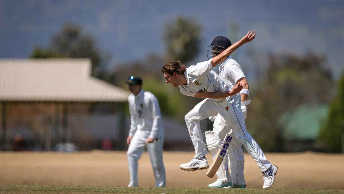 Tasmania's Lawrence Neil-Smith runs in and hits the crease hard. Picture by James Wiltshire