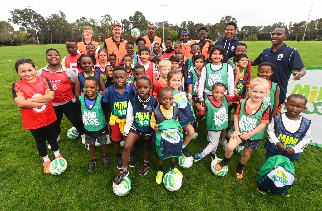 DREAM TEAM: Wodonga Heart's coaches and the children who have been part of the multicultural miniroos program. Pictures: MARK JESSER
