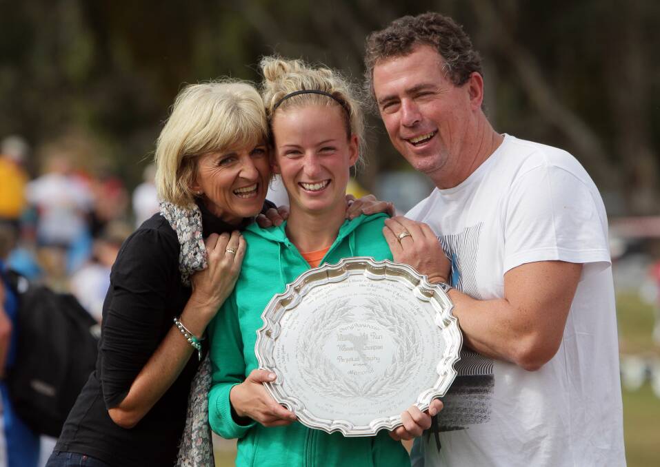 HISTORY: Ellie Pashley celebrates winning the 2011 Nail Can Hill Run with mum Pauline and dad Brendan. A decade on, she's about to race the Olympic marathon.