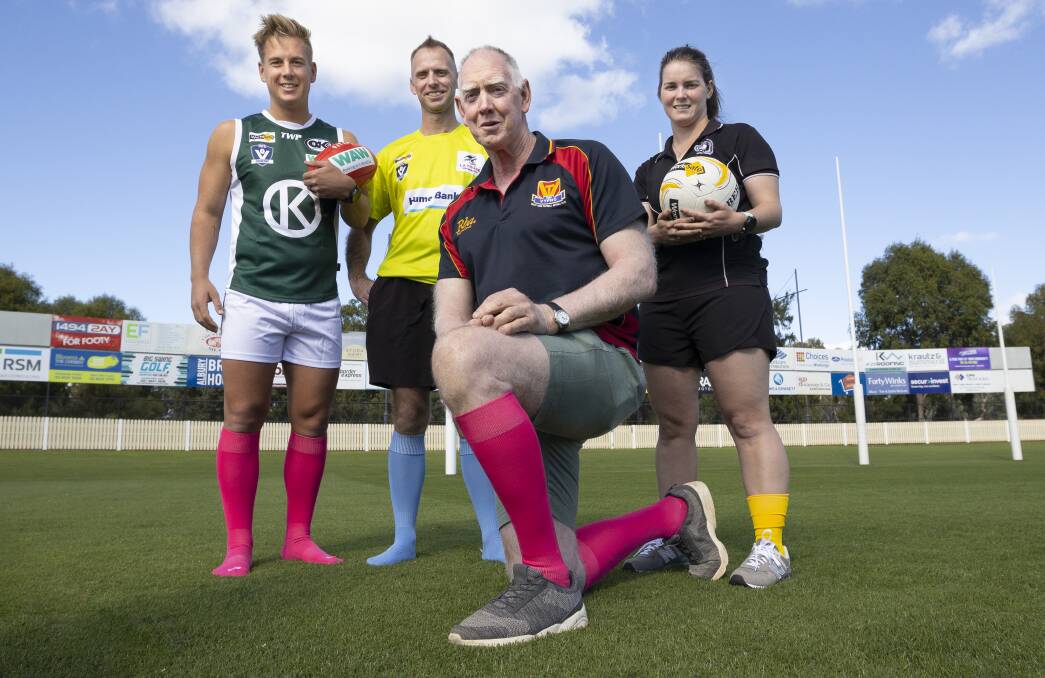 COLOUR POP: Former O&M football star Terry Greaves (kneeling) launched his fundraiser, Terry Socks it to Cancer, with AFL North East Border league manager Cam Green, Michael Bocquet and Chaye Crimmins. Picture: ASH SMITH 
