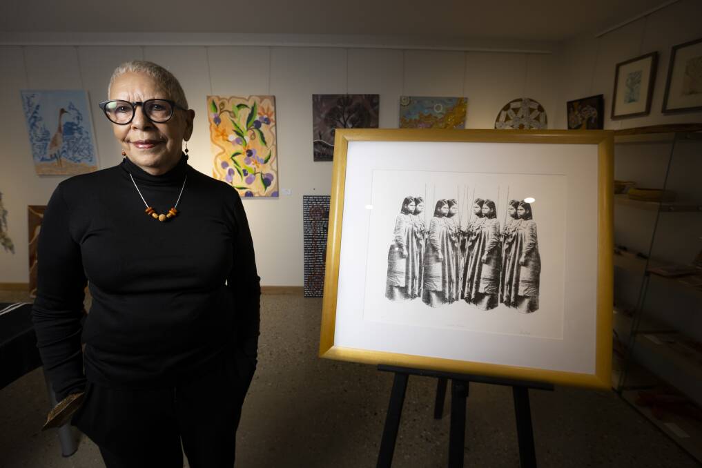 FAMILY TIES: Indigenous artist Glennys Briggs with one of her artworks depicting her late great-grandmother Annie Hamilton. Picture: ASH SMITH