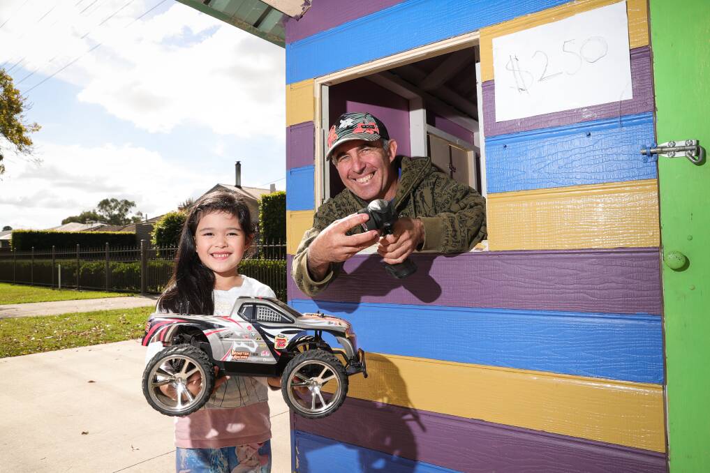 OLD TOY: John Portsmouth and his daughter Ariana, 6, with their dollhouse at the Jindera Community Garage Sale. Picture: JAMES WILTSHIRE