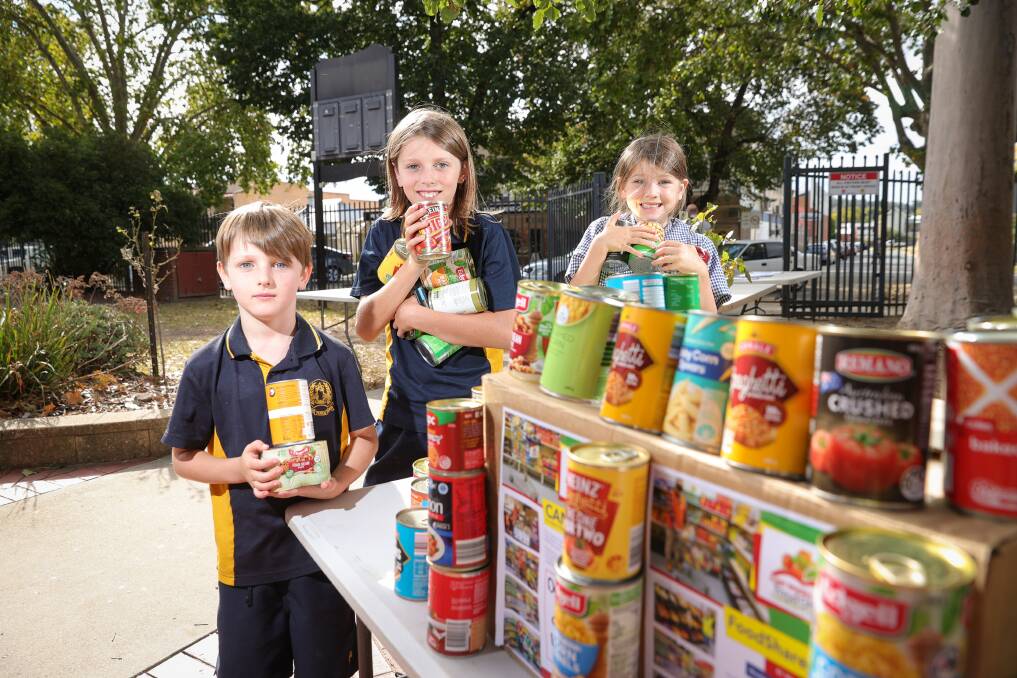 FAMILY AFFAIR: Albury Public School donated 164kg of food, or 400 cans, for Mission Australia's Can Food Drive in Term 2. Students and siblings Jasper, 7, Reece, 10, and Bronte Fellows, 5. Picture: JAMES WILTSHIRE
