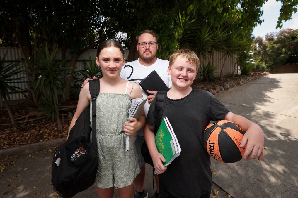 Single father John Torpy with his children, Brilee, 12, and Daniel, 10, are looking forward to returning to school but are worried about the price spikes. Picture by James Wiltshire.