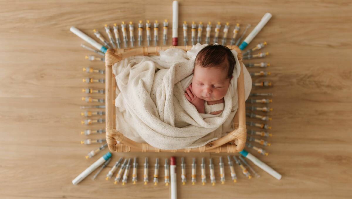 Two-week old Colton Pleming surrounded with about 65 needles from their IVF journey. "Hes so perfect, worth the wait, every shot, tear, and years," Mrs Pleming says. Picture by Ash Henderson Photography.