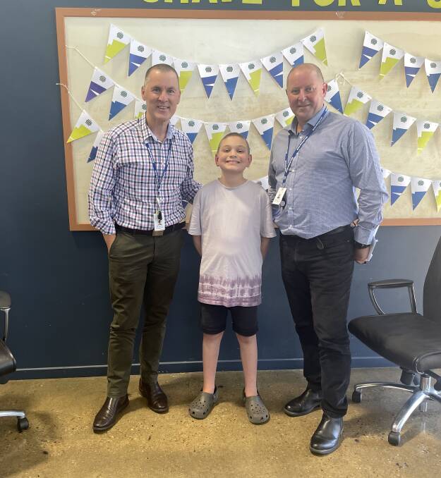 Albury Wodonga Health's chief executive Bill Appleby and Albury Wodonga Health chief of infrastructure Shaun Strachan with Harry Doughty, 10, after having their heads shaved. Picture supplied. 