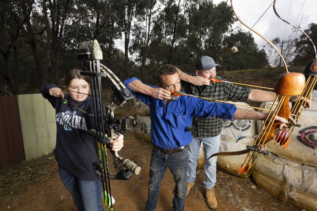TARGET: Lily Art, 12, Brendan Ross and Zoran Art take aim to shoot. Picture: ASH SMITH