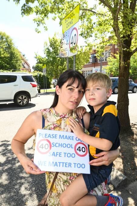 Frustration over the sign that sits directly out the front of the school but "in no way anything to do with the school" makes Leanette Moreland and her son Lincoln, 5, stressed about school pick-up's and drop-off's.