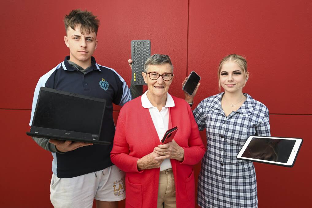 Wodonga's Sandra Temple, 79, with students Curtis Grasso and Gwen Rivett, both 15, enjoy connecting over technology and how to use smart devices. Picture by Mark Jesser