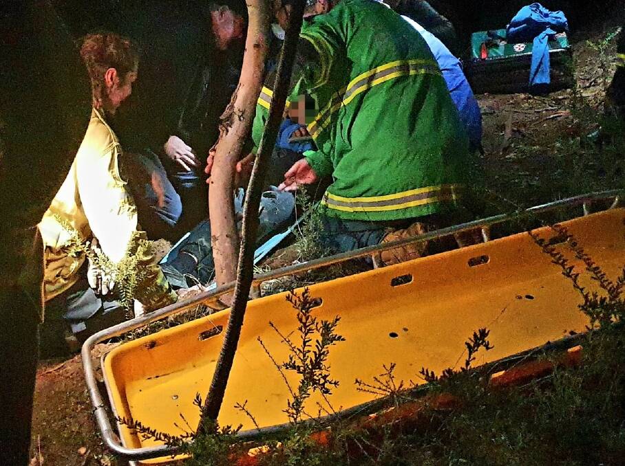 EVENING RESCUE: Emergency workers help the injured teenager at Nail Can Hill on Saturday. Picture: ALBURY AND BORDER RESCUE SQUAD