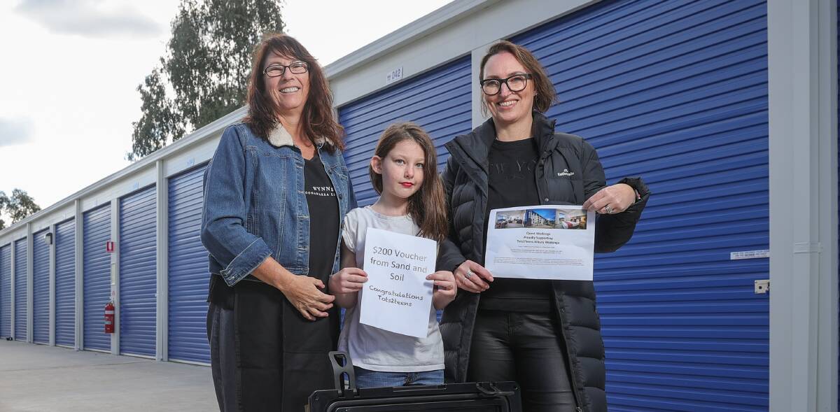 GOAL TICKED: Owner of Tots2Teens Joanne Knight with daughter Caitlin,10, and highest seller Noeline Elvin-Wild with paperwork related to prizes for the annual pie run. Picture: JAMES WILTSHIRE