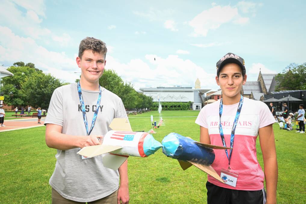 Ben Sidgwick, 15, and Katie Gillis, 13, built rockets from a 2-litter bottle. They then filled it with water and air and counted down until it blasted off. Picture by Mark Jesser.