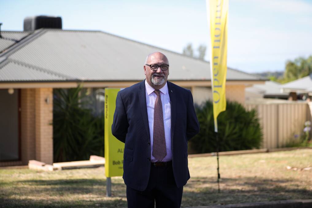 Agent Bob Packer cut a lonely figure at the "auction" on Saturday morning of this three-bedroom brick home at Springdale Heights. Picture by James Wiltshire