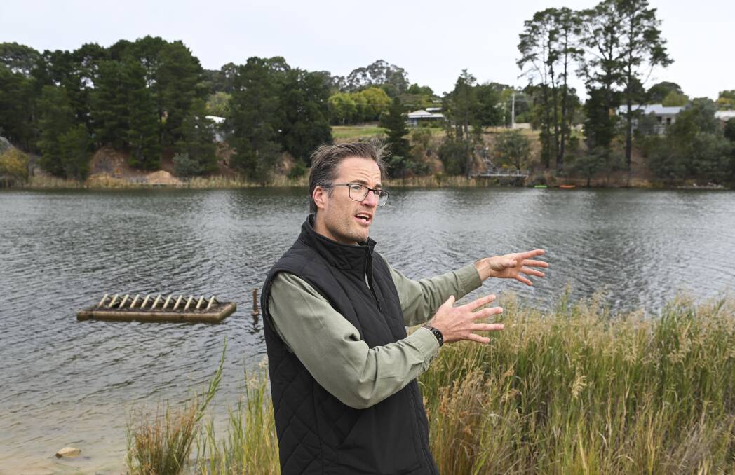 Beechworth businessman Michael Patterson on the shore of Lake Sambell shows where the floating sauna project will be crane lifted into the water "hopefully in spring". Picture by Mark Jesser