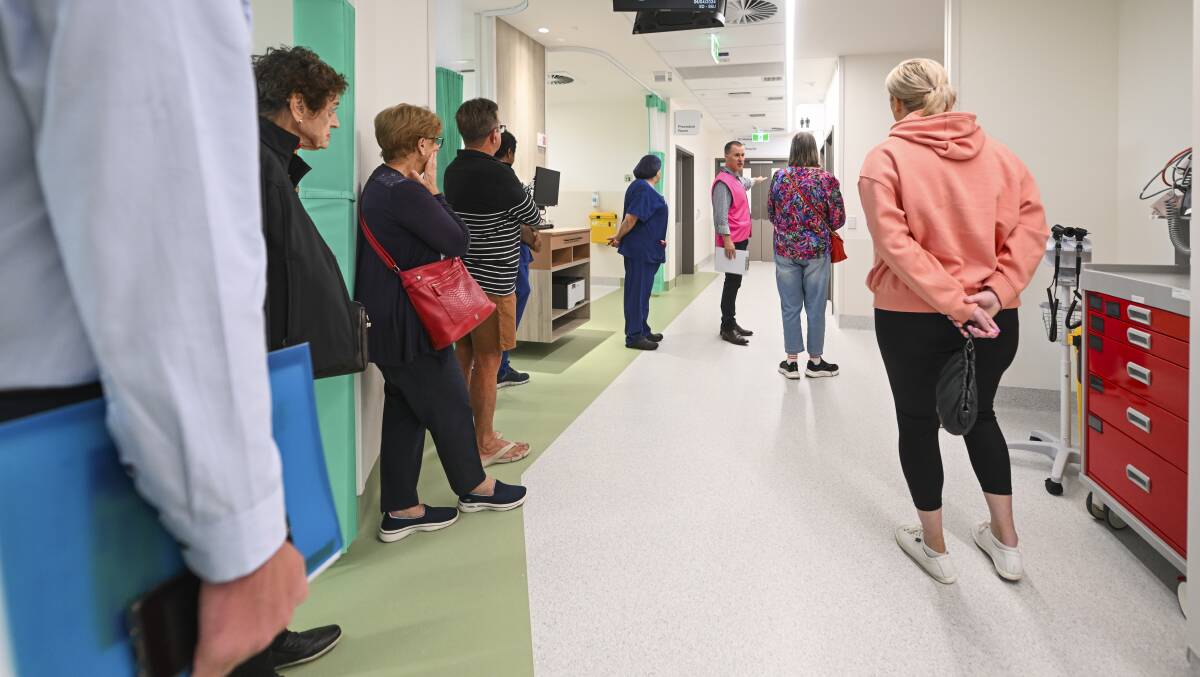 Albury Wodonga Health chief executive Bill Appleby leads a group through the new emergency department on Saturday, April 6. Picture by Mark Jesser