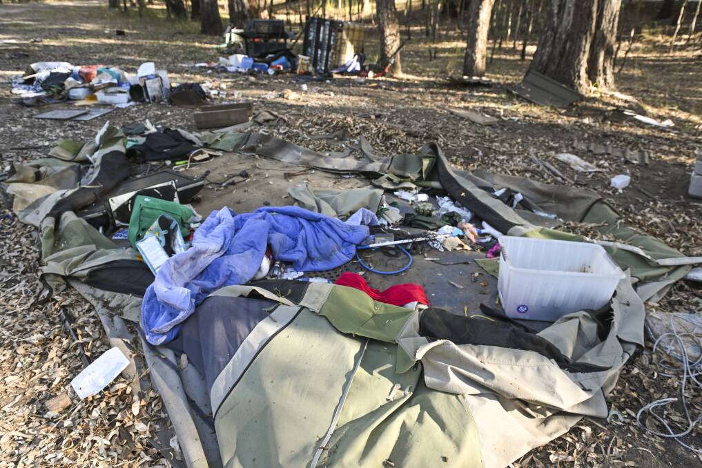 The collapsed tent in the middle of the debris strewn around the site just metres from the Murray River. Picture by Mark Jesser