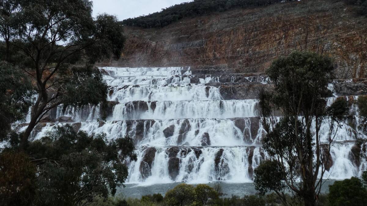 Dartmouth Dam keeps spilling over on Wednesday as thousands of eager sightseers flock to the town boosting pub and motel trade. Picture by Maggie Charlwood