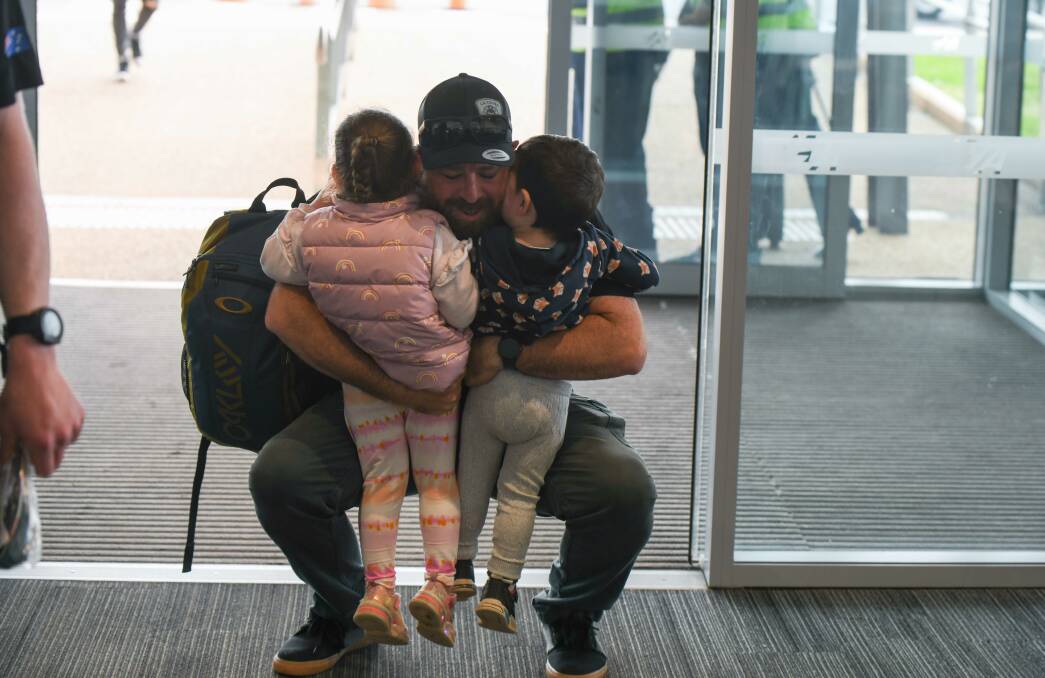 "Welcome back Dad" - Ovens firie Casey Healy gets a warm welcome from his daughters Isla, 3, and Asher, 2. Picture by Tara Trewhella