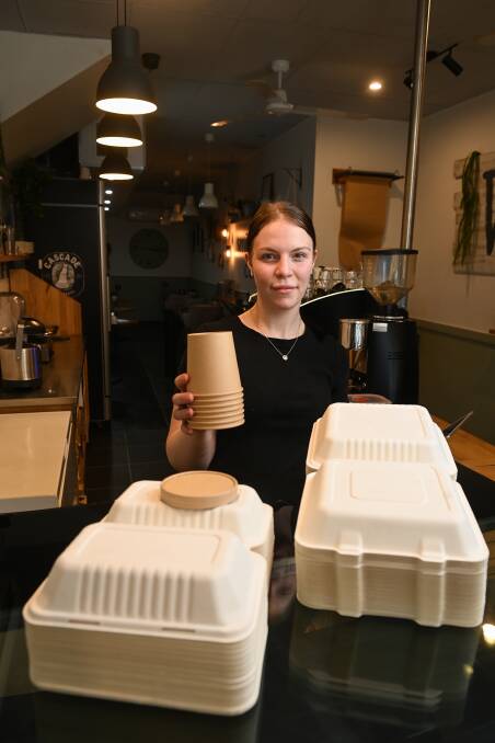 ECO-FRIENDLY: Food and beverage attendant Olivia Wentworth shows cardboard food containers at Willow and Co Coffee Shop on Dean Street. Picture: MARK JESSER