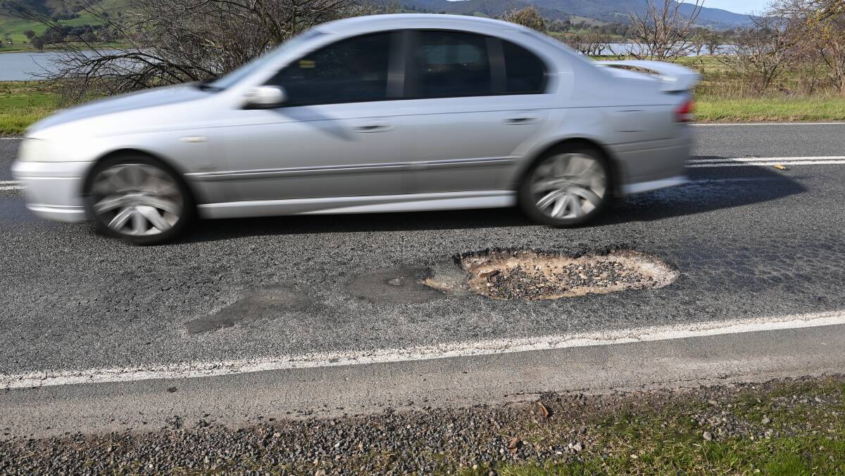  A car swerves to avoid a pothole on the Murray Valley Highway at Huon. Picture by Mark Jesser
