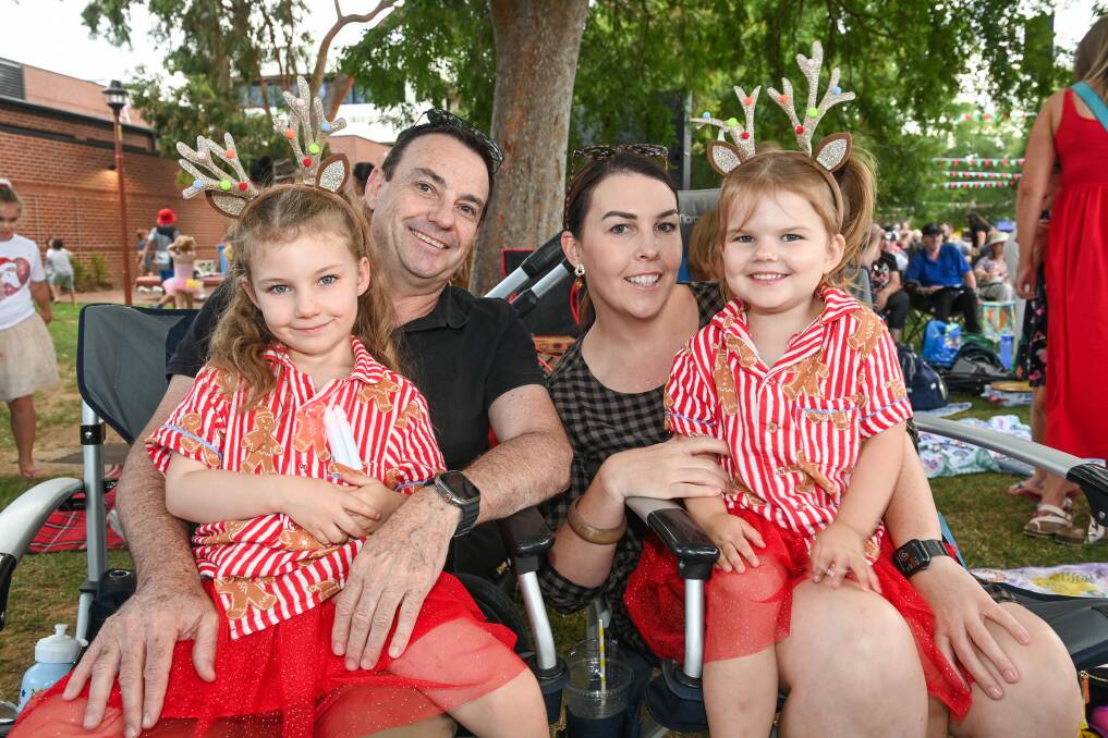 Zara Sheather, 5, and Mia Sheather, 3, with parents Tim Sheather and Jacinta Almond, of Thurgoona, at Albury's Carols by Candlelight at QEII Square on Wednesday, December 20. Picture by Mark Jesser