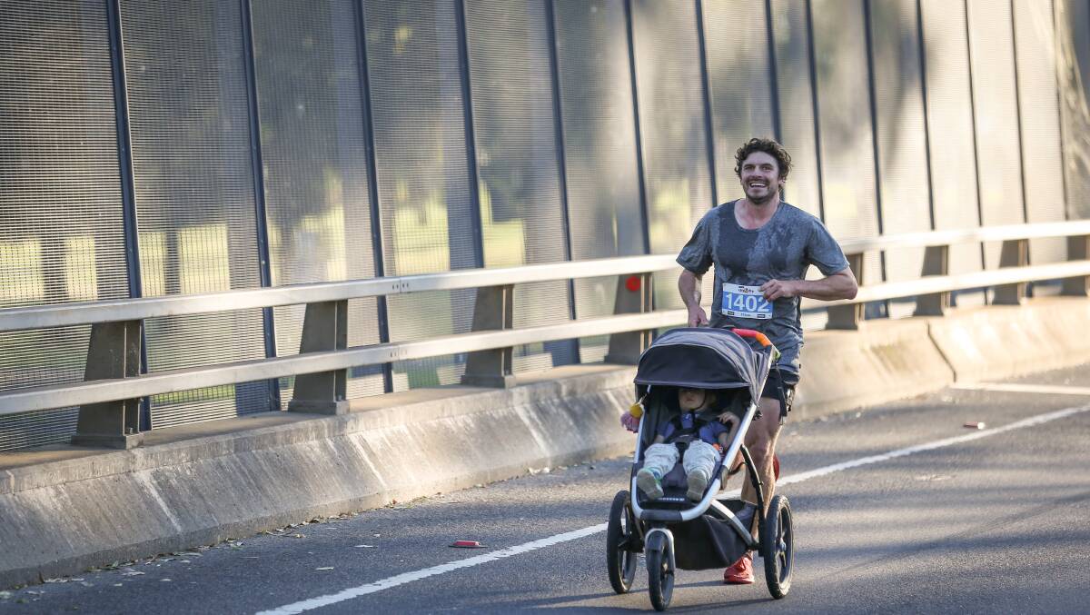 Riordan Bell pushed his limits of endurance - and his toddler, Finlay - to reach the finish line. Picture by James Wiltshire