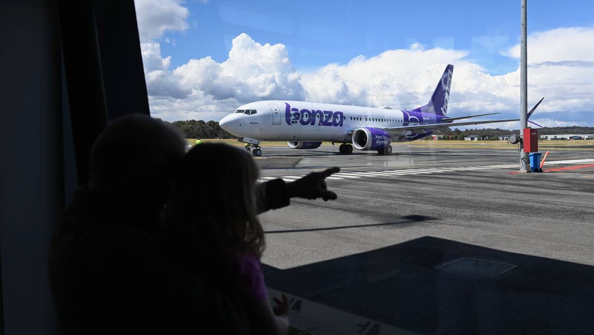 Onlookers gaze at the Bonza Boeing 737 Max 8 named "Bazza" at Albury Airport on Monday afternoon. Picture by Mark Jesser