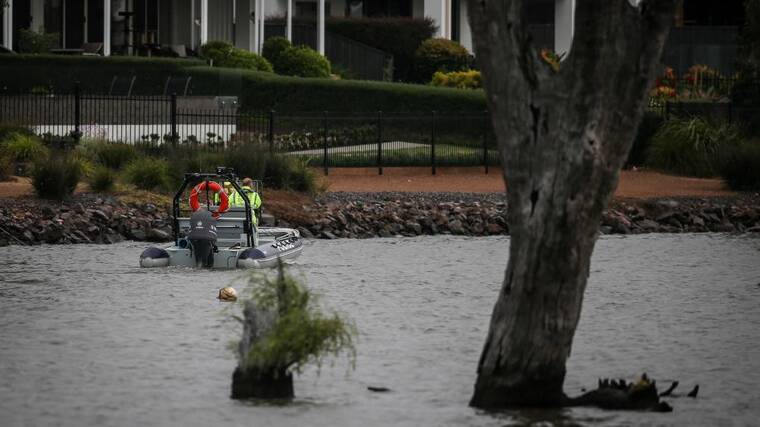 Police near the shore of Lake Mulwala at Yarrawonga's Silverwoods Estate on Sunday. Picture by James Wiltshire.