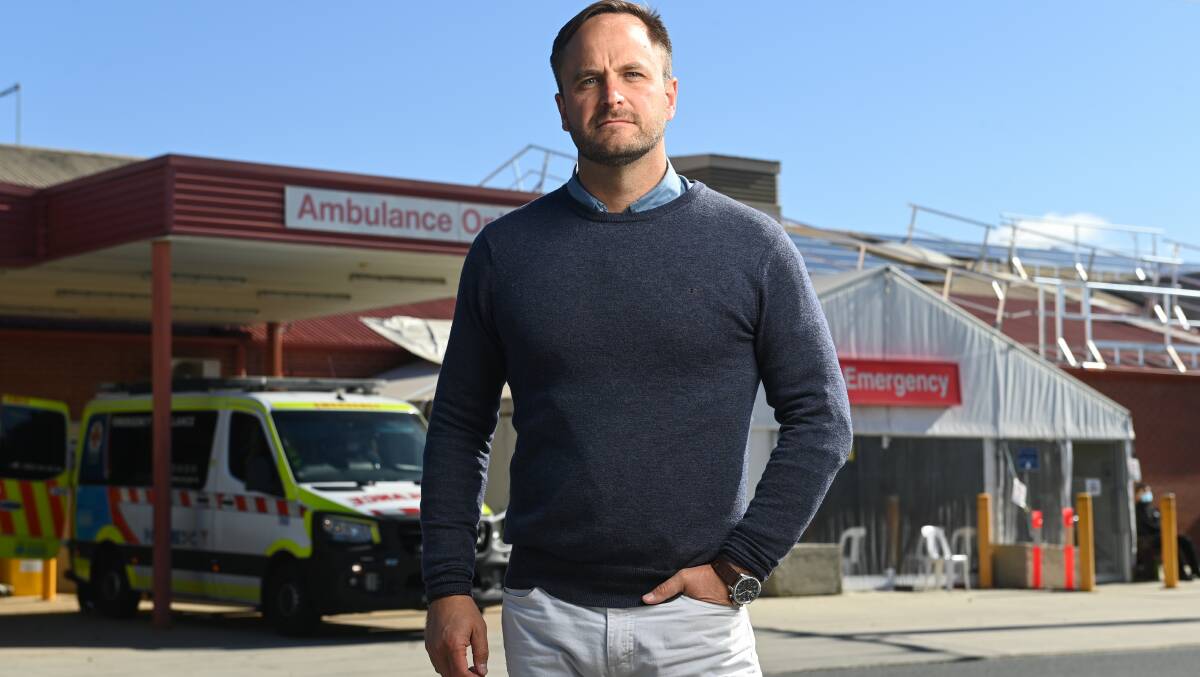 SEEKING RESOLUTION: Ross Lyman voices his support for Justin Clancy's parliamentary address at Wodonga Hospital yesterday morning. Picture: MARK JESSER