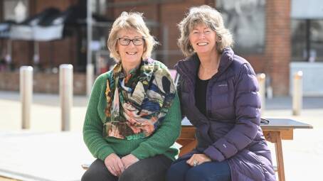 PLAYING IT SAFE: Judy Hawkins, 64, and Linda Adler, 62, catch up at Junction Square, but with the risk of COVID, prefer to sit outside rather than eat in restaurants. Picture: MARK JESSER