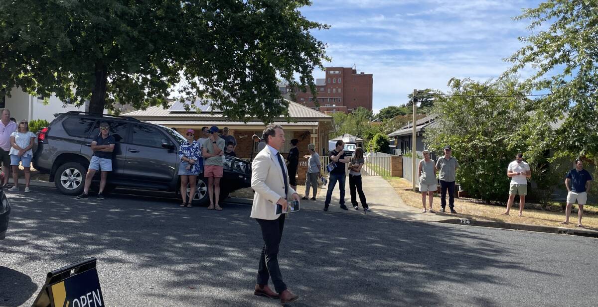 Auctioneer Lachlan Hutchins addresses the crowd of about 60 at Jones Street late on Saturday morning. Picture by Ted Howes