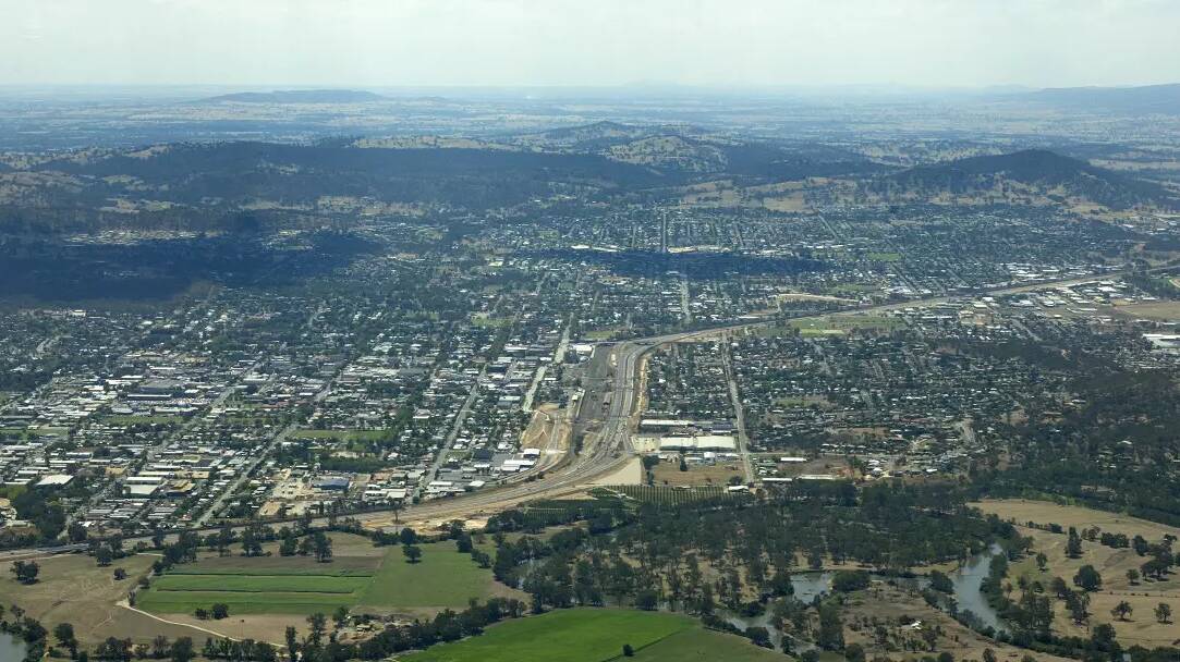 Aerial view of Albury-Wodonga during the Hume freeway construction in 2007. A state MP says investors will look across the Murray to find properties due to Victoria's broad land tax policy. File picture

